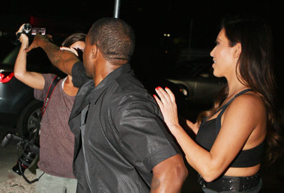 Kanye west trys to take female paparazzi's camera while on date with kim kardashian at the prime 112 in miami beach.