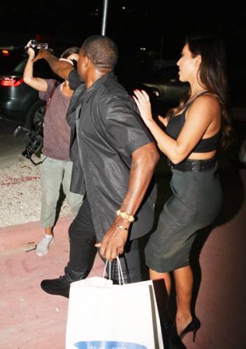 Kanye west trys to take female paparazzi's camera while on date with kim kardashian at the prime 112 in miami beach.